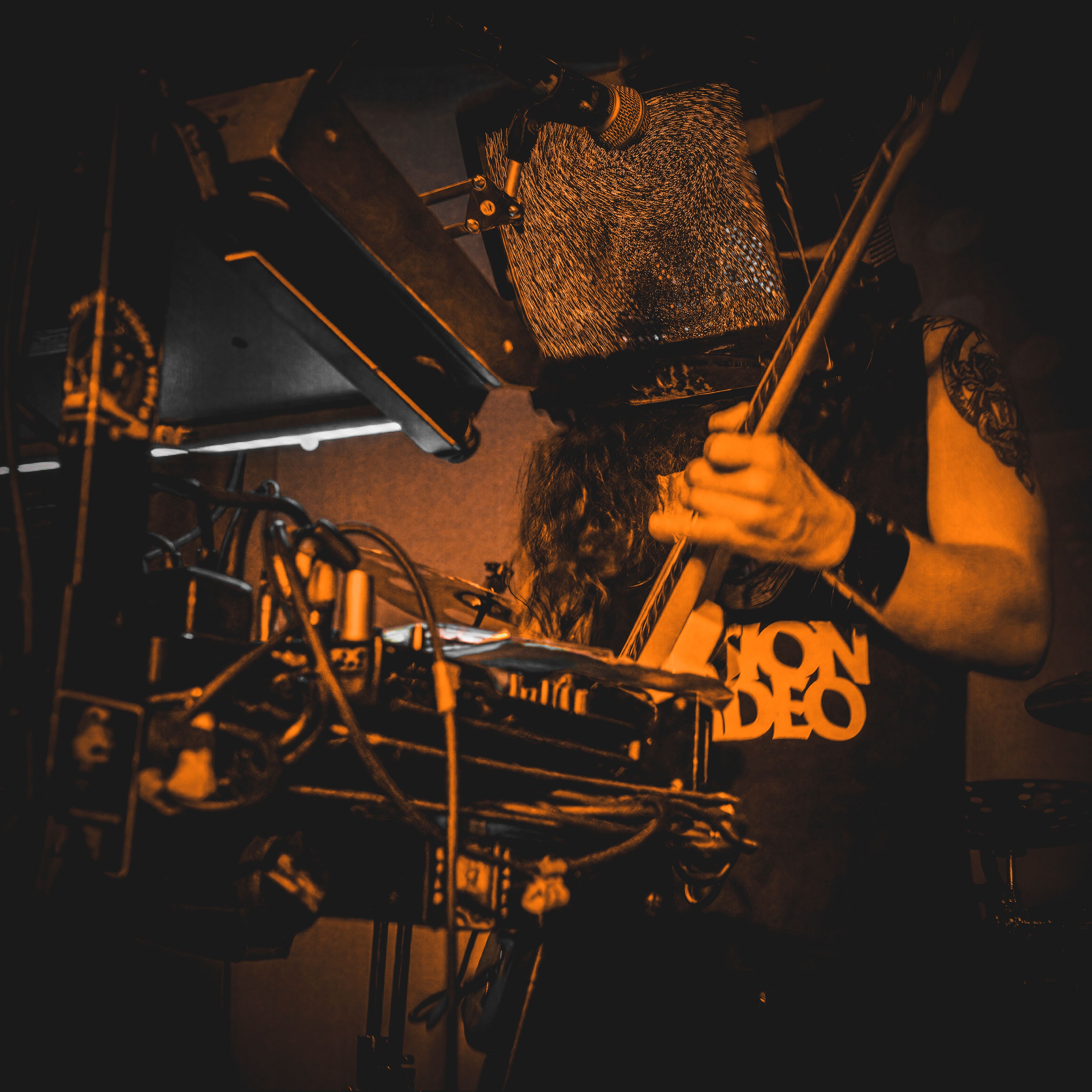 Jaguardini performing at Snug Harbor with guitar, synths and a CRT television on his head