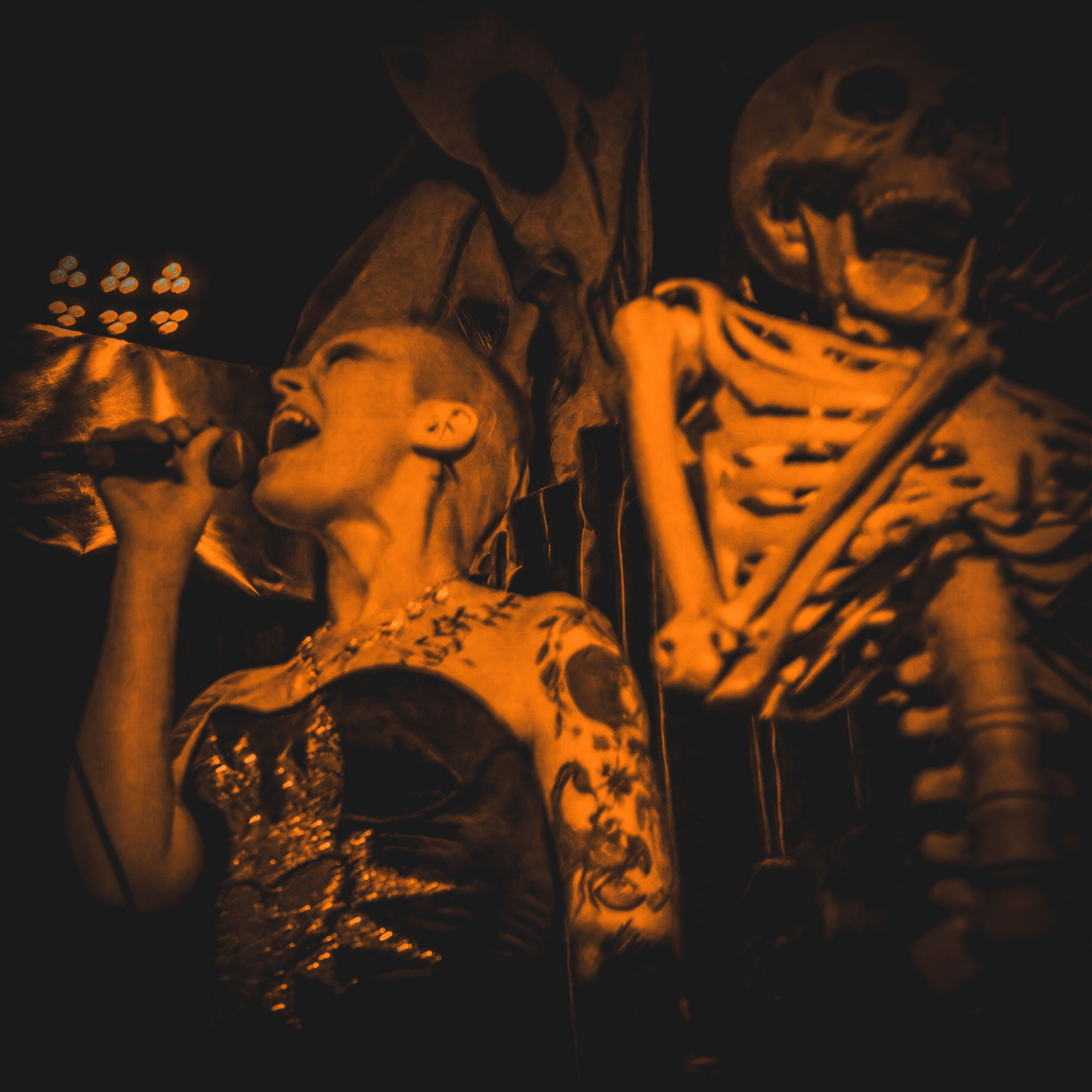 Mickey Sharp singing into a microphone in skull makeup at Snug Harbor